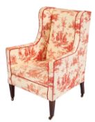An Edwardian stained beech semi-wing frame armchair,