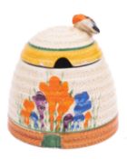 A Clarice Cliff Bizarre beehive honeypot and cover decorated in the 'Autumn Crocus' pattern,