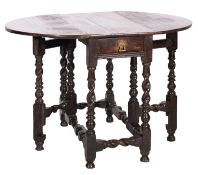 A William and Mary oak gateleg table, late 17th century; the oval top with twin drop leaves,