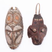 A carved, painted and shell inset mask, Sepik River, Papua New Guinea,