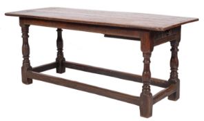 An 18th Century oak dining table of refectory type,