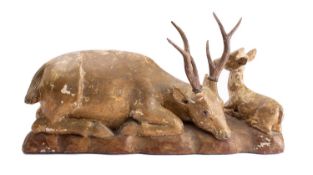 A carved and giltwood group of a stag and a fawn, late 19th century; naturalistically modelled,