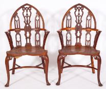 A set of four yew-wood and elm Gothic Windsor elbow chairs in the 18th Century manner,