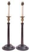 A pair of Edwardian mahogany and brass mounted table lamps, in the manner of George II candlesticks,