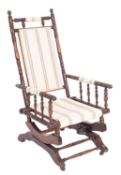 An Edwardian American type turned beech frame rocking armchair,