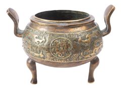 A Chinese bronze tripod censor with pierced upswept handles,