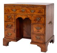 A George II walnut and feather and crossbanded kneehole desk,