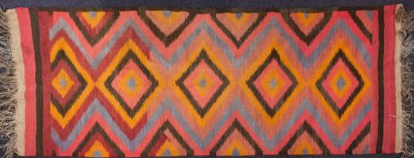 An Afghan Kelim, the serrated lozenge field in colours of pink, orange, puce, brown and pastel blue,