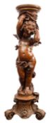 An Italian carved wood, gessoed and parcel gilt figural torchere stand, in Rococo Revival style,
