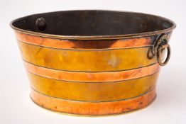 A brass and copper bound wine cooler,
