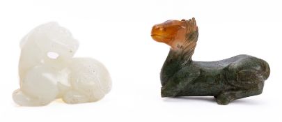 A Chinese pale celadon jade carving of a mythical beast together with a spinach and russet jade