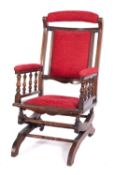 A late 19th Century American type stained beech rocking armchair,
