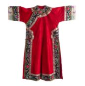 A Chinese lady's red-ground silk damask robe trimmed with black silk borders embroidered with