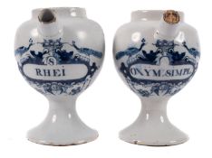 A pair of Dutch delftware blue and white wet drug jars the 'peacock' labels inscribed 'S Rhei' and