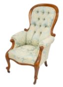 A Victorian walnut and button upholstered 'spoonback' armchair,