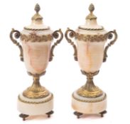 A pair of French onyx and gilt metal mounted urns,