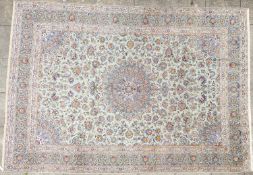 A Kashan carpet, the pastel blue field with a central circular flowerhead pole medallion,