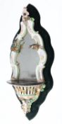 A pair of large German porcelain mirrored brackets of rococo outline with flower and foliate