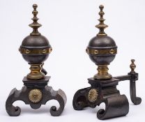 A pair of cast iron and brass mounted andirons in Mediaeval taste,