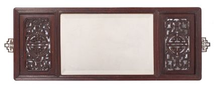 A Chinese carved and stained hardwood framed wall mirror,