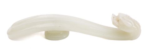 A Chinese jade 'dragon' belt hook in archaic style, the shaft with raised concave centre panel,