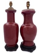 A Chinese 'sang-de-boeuf' glazed rouleau vase and a similar baluster vase,