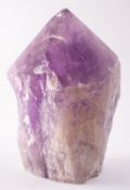A large specimen of amethyst quartz; partially polished to the faceted top;