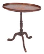 A late George III mahogany oval snap top occasional table,