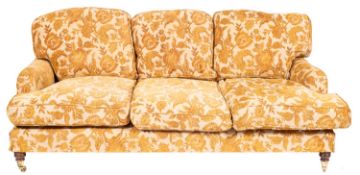 An upholstered three seat sofa in the style of Howard & Sons, by Kingsley & Son,