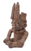 A Pre-Colombian/Mayan pottery vessel of Hun Hunahpu in seated posture wearing a maize head dress,
