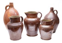 Two salt glazed ewers and three salt glazed tavern jugs, tallest 47cm high and repaired.
