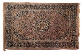 A Bijar rug, the shaded rose cartouche field with a central indigo and ivory lozenge pole medallion,
