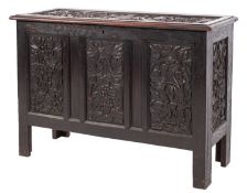 An oak coffer in 17th Century taste and Arts & Crafts style, circa 1900; the hinged cover,