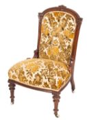 A late Victorian carved walnut and button upholstered salon chair,