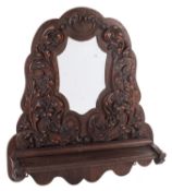 A Victorian carved oak framed wall mirror with shelf,