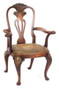 A carved walnut and beechwood and parcel gilt open armchair in George I style;