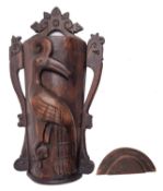 A Burmese carved and stained hardwood hod, Naga tribe; of tapering semi-cylindrical form,