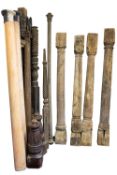 A collection of carved wood columns, previously architectural and bedposts,