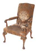 A stained beech open armchair in the George II style, having an upholstered stuff over back,