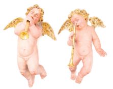 A pair of painted plaster models of angels,