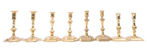 Four pairs of George III brass candlesticks,