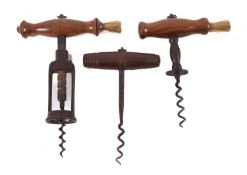 A 19th Century corkscrew, with turned wood handle and brush,