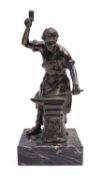 A patinated metal sculpture portraying a smith at work, circa 1930; standing at his anvil,