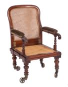 A Victorian mahogany and canework campaign elbow chair, by J.