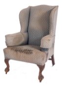 A mahogany and stained beech wing frame armchair in the George II taste, fully upholstered,