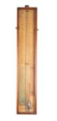 An oak cased Admiral Fitzroy's barometer the paper dials showing barometric rises and falls along