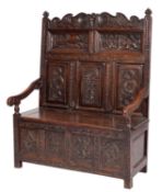 A carved oak bacon settle in, late 17th century taste,