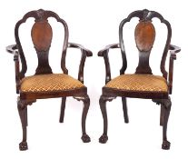 A pair of Edwardian mahogany open armchairs in the Queen Anne taste,