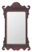 A mahogany framed rectangular wall mirror in George I style, 19th century; with fret-cut surround,