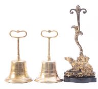A pair of Victorian brass door porters modelled as half bells,